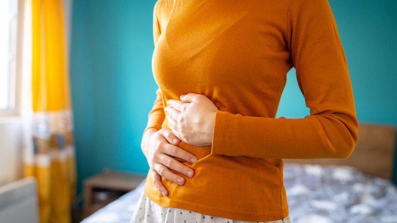 A woman holding her stomach
