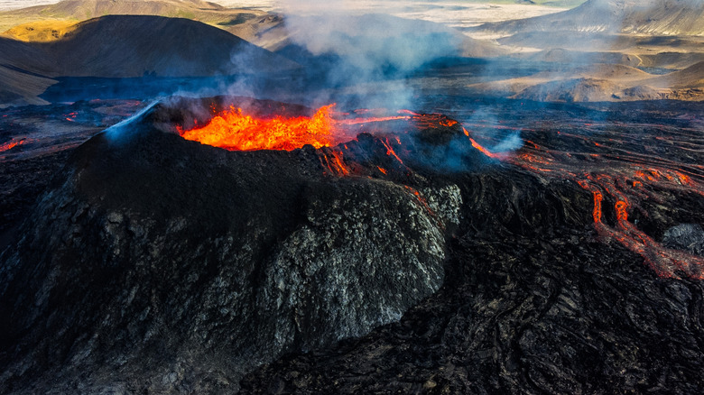 Bubbling and smoking volcano with the land around it destroyed