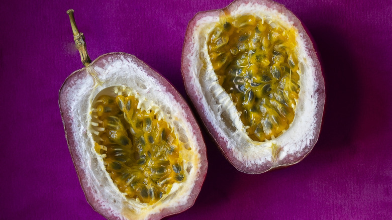 Two Cut Passionfruit Halves on Pink Velvet