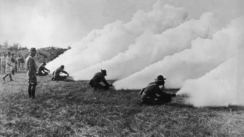 soldiers releasing smoke from chemical cylinders at the Army Chemical Warfare Service School at Edgewood Arsenal in Maryland