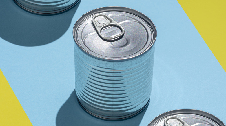 silver food tin on blue and yellow background