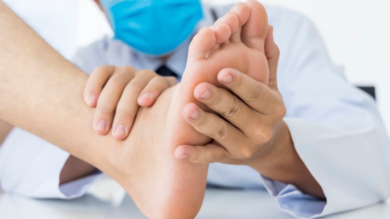 Doctor holding the sole of a patient's foot