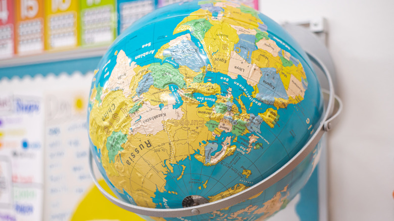 Raised relief globe with Asia, Europe, and Africa visible.