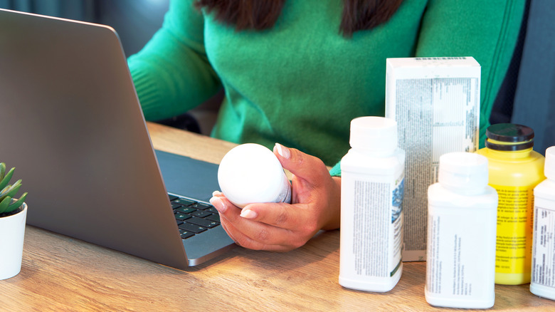 Woman researching various bottle information online