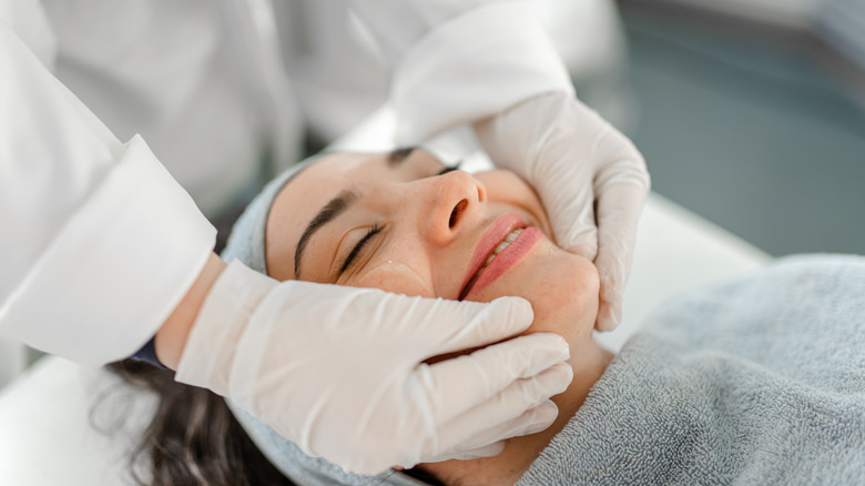 Woman receiving a facial treatment