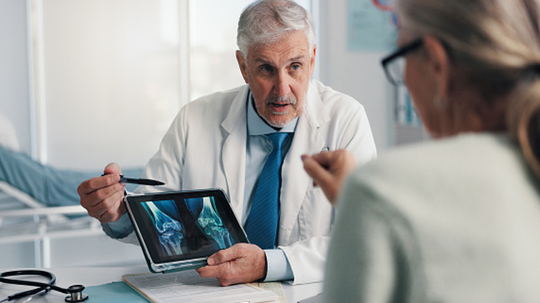 Doctor showing bone images to patient