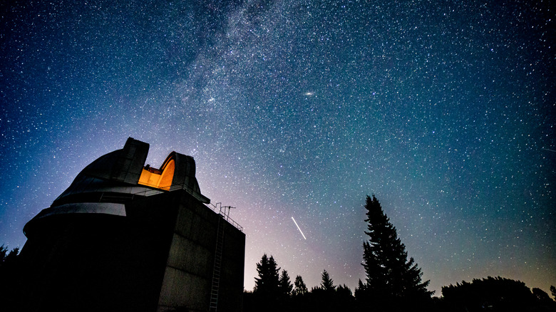 Milky Way crossing the night sky above the dome of an observatory