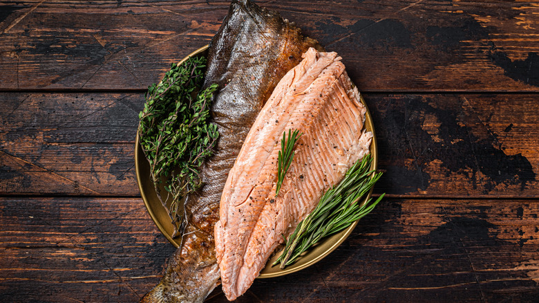 Cooked trout fillet in a bowl with greens