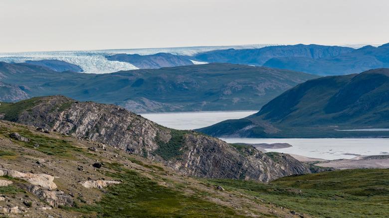 Greenland hills with small melting glaciers in their nadirs