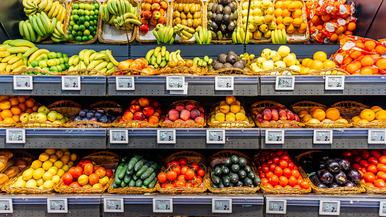 A selection of various fruits on a shelf in a supermarket
