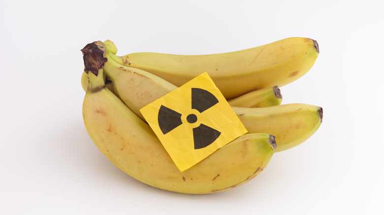 A bunch of bananas with a radioactive symbol sticker on top