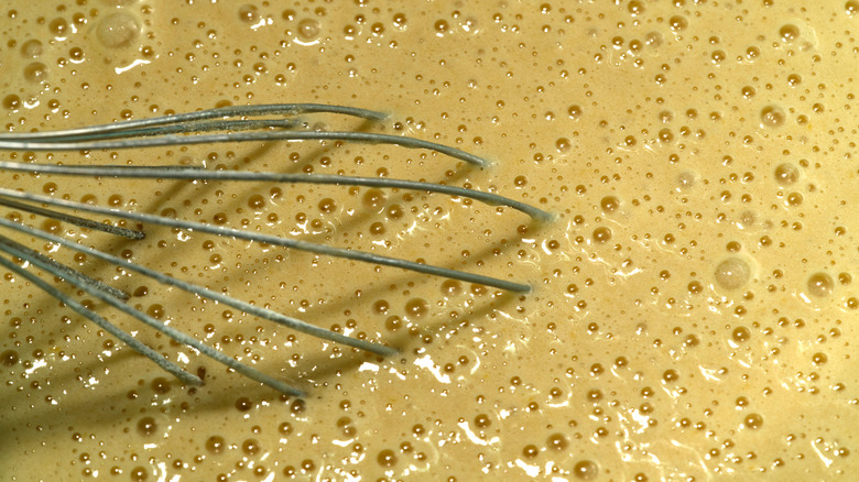 Close up of dough batter with bubbles of carbon dioxide