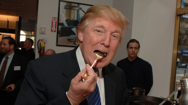 Donald Trump putting fork into mouth