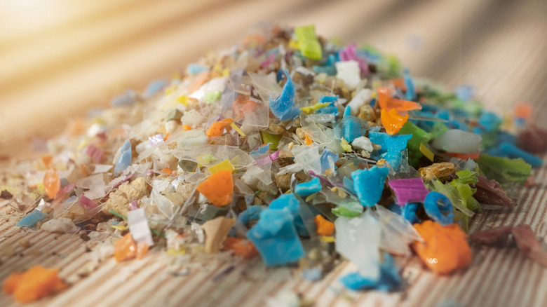 A pile of microplastics sits on a wooden surface