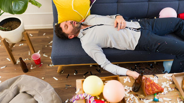 Man falling asleep at party after drinking