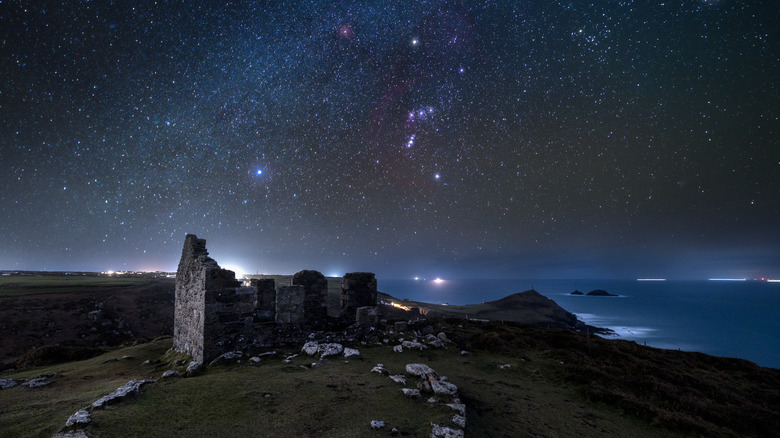 Stars in the night sky above stone ruins