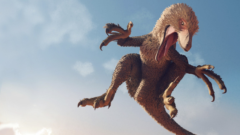 A dinosaur is seen jumping against a blue sky