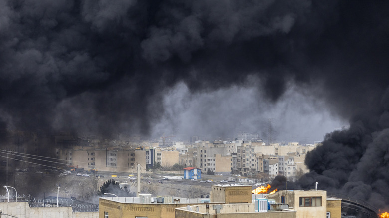 Black smoke billows following an airstrike in Iran.