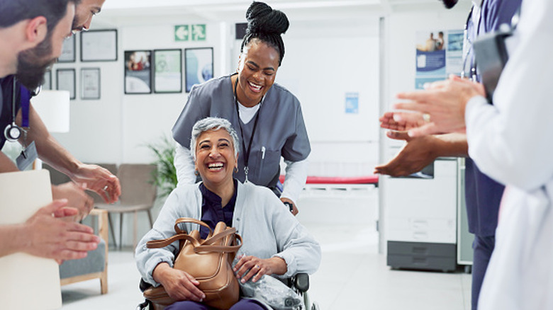 Patient in a wheelchair leaving a hospital
