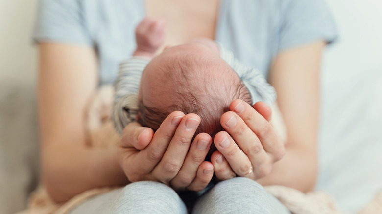 A newborn in a mother's hands