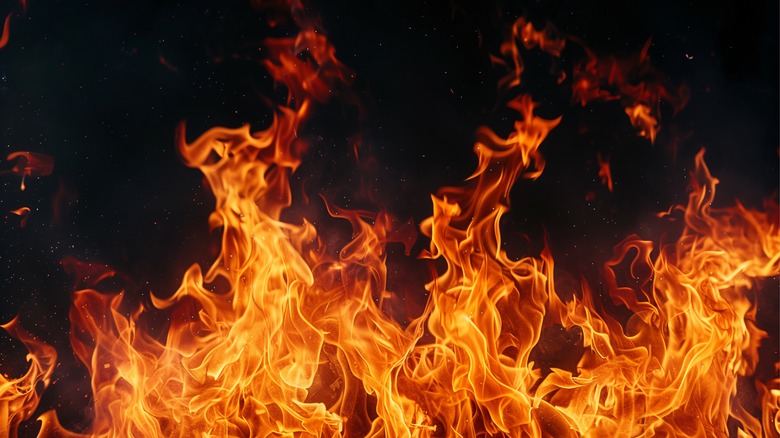 Fire is burning against dark background