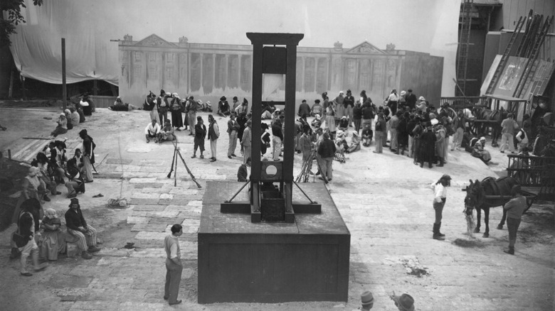 A crew is setting up a guillotine