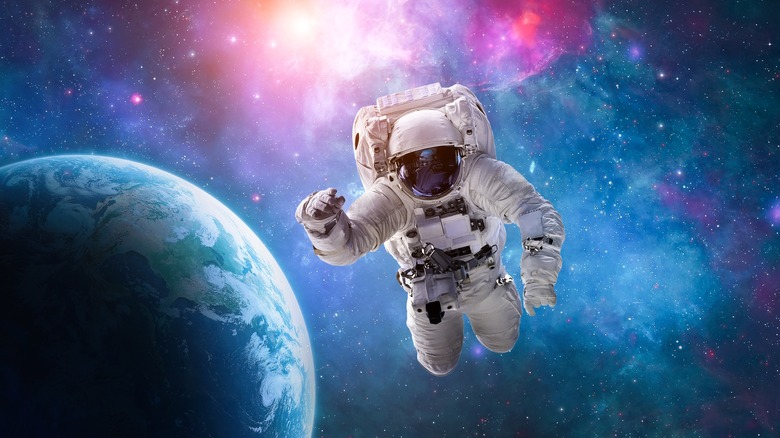 Astronaut in a space suit is floating in space