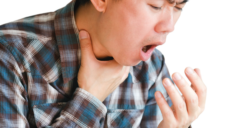 Asphyxiating man with hand on his throat
