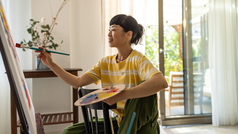 Woman painting on a canvas