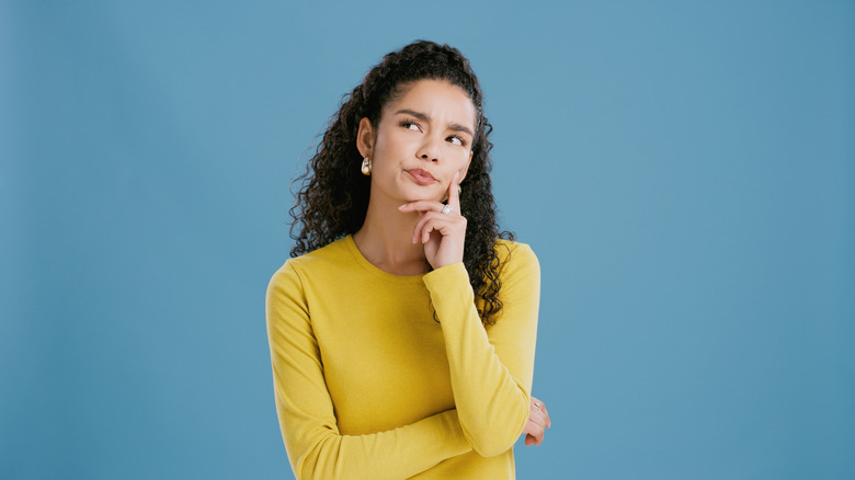 Pensive woman looking like she's trying to recall something
