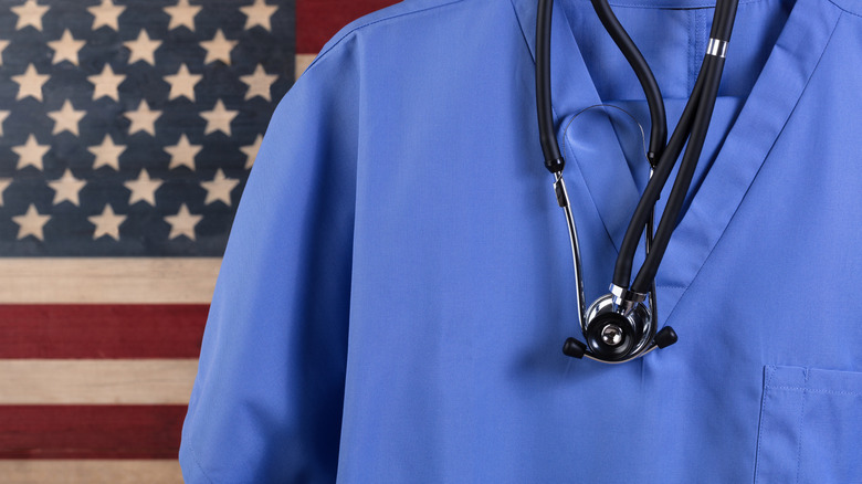 Doctor robes and stethoscope positioned in front of American flag