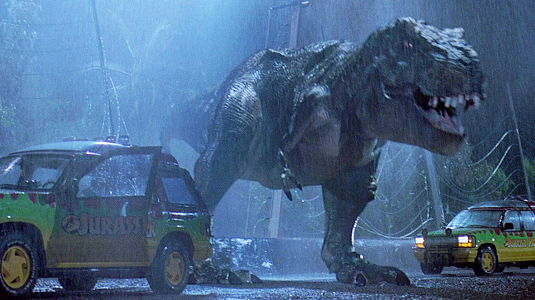 The T. rex stands between two Ford Explorers in Jurassic Park