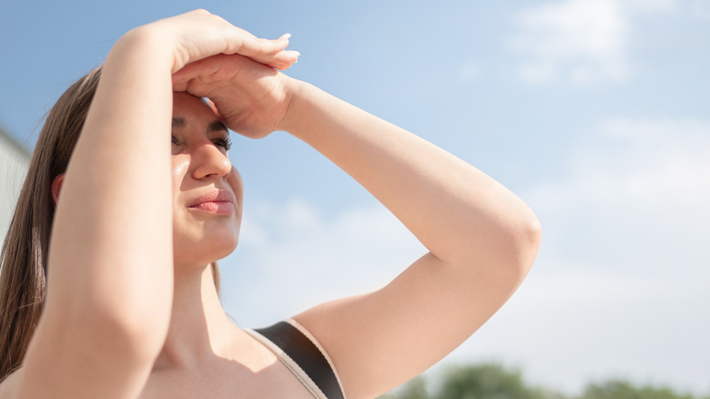 Woman shielding her eyes from the sun