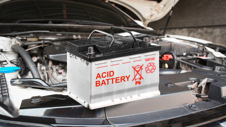 A lead acid battery placed under the hood of a car