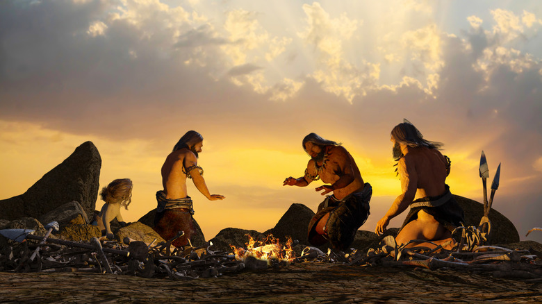 3D art of cavemen around a fire