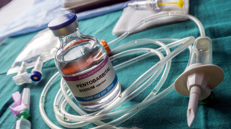 Vial of pentobarbital on medical tray surrounded by IV tubing