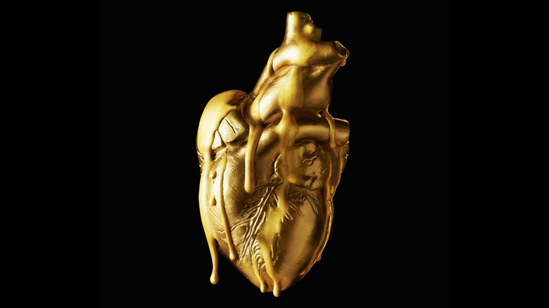 Concept of a gold human heart dripping in "golden blood"
