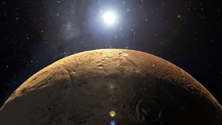 Close-up of top half of Pluto with the sun shining in the distance