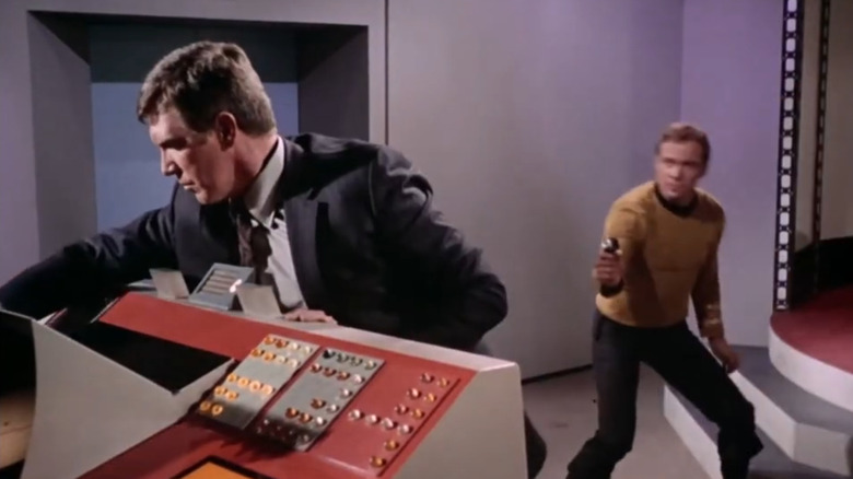 Captain Kirk about to fire his phaser