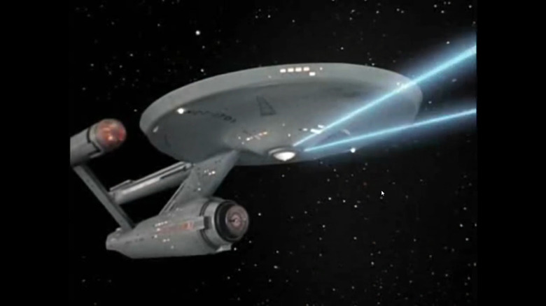 The USS Enterprise firing its phasers in space