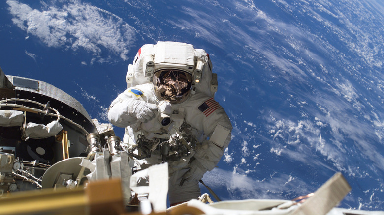 Astronaut in space suit working on outside of the International Space Station