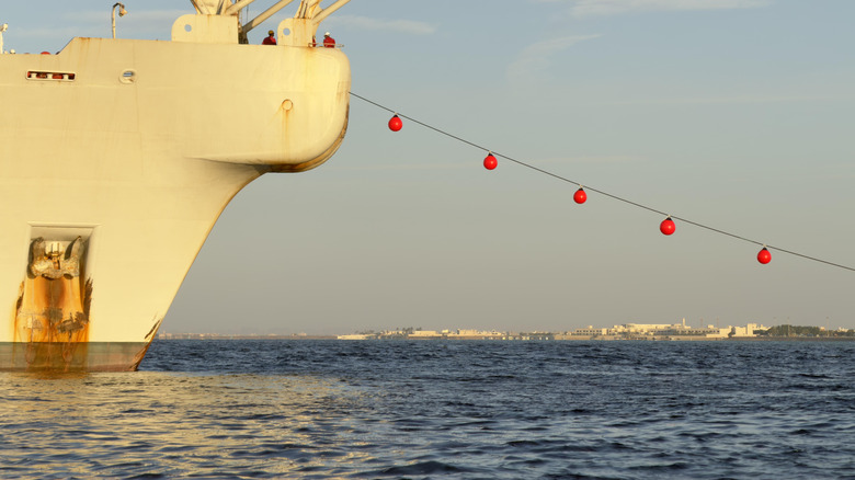 A cable-laying ship sets a fiber optic cable under water.