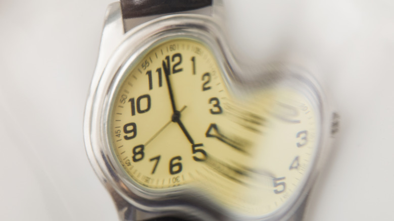A blurred and stretched image of a watch
