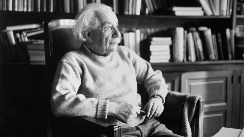 Albert Einstein seated in office chair