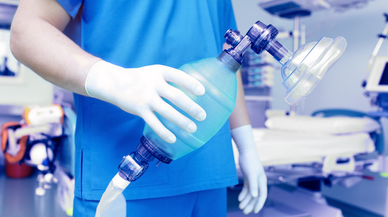 Medical professional holding a breathing apparatus for resuscitation