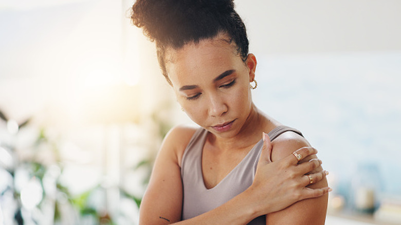 A woman with a sore shoulder