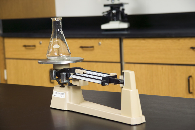 Glass flask on triple beam balance