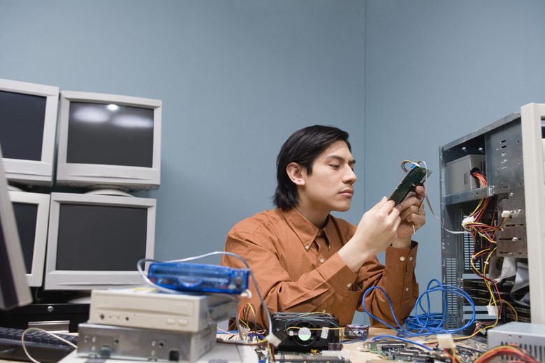Man looking at dismantled technology