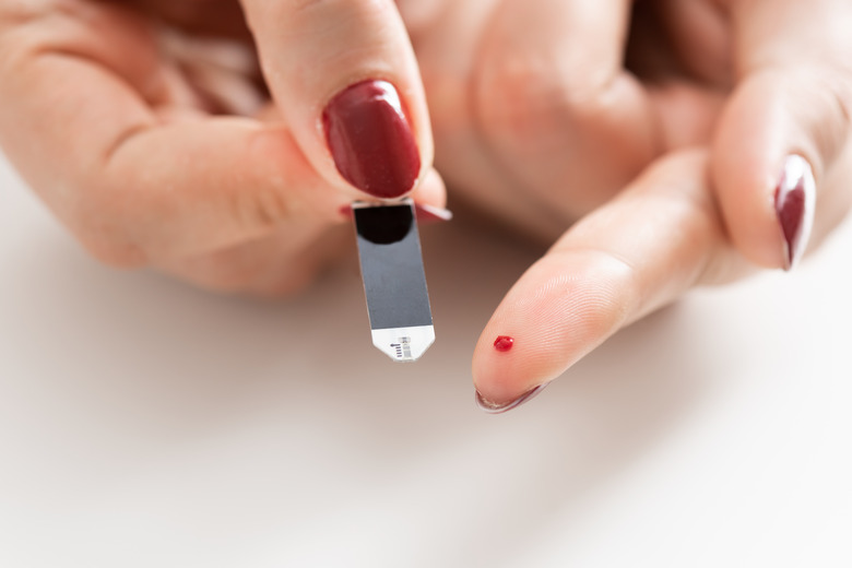 Woman checking blood sugar level