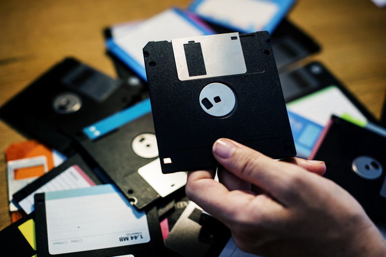 Hand holding floppy disk drive data storage
